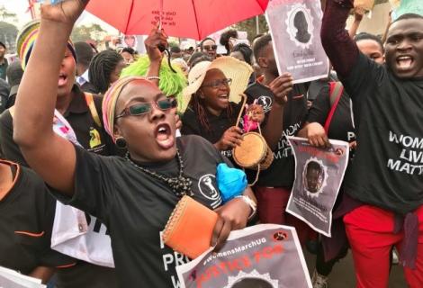 Women match during a protest against increased  women murders in Uganda