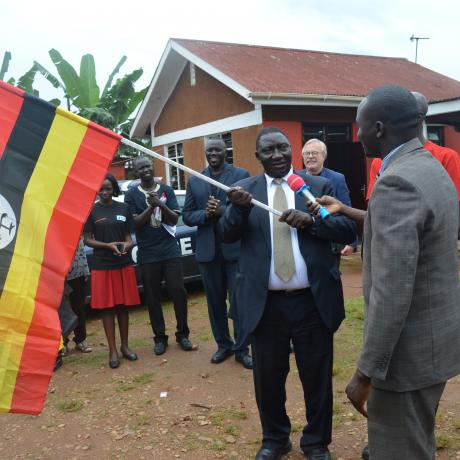 Pakwach District Chairman and anti corruption ambassador 2019,Omito Robert Steen recives a flag from Ethics PS Alex Okello during the flag off