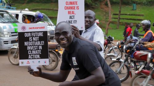 David Asubu and Acellam, both regional program officers for North and East, respectively participate in the climate justice march.