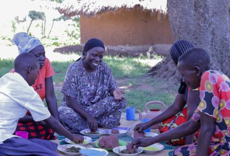 Naima Isa, the Board Liason Officer, AAIU, shares a meal with her host family.