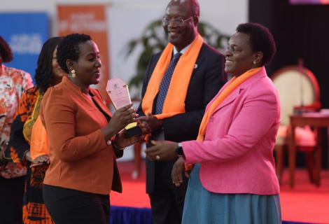 Angel Akoth, the GBV Coordinator at ActionAid International receives her award from Hon. Peace Mutuzo