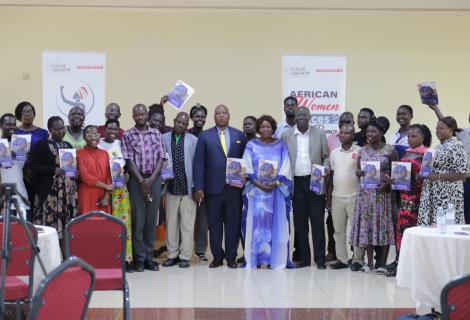 Participants take a group photo with copies of the brief during the launch