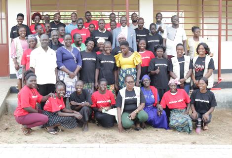 Residents of Imvepi Refugee Settlement join staff for a group picture after the launch
