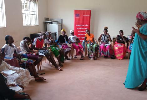 ActionAid legal officer, Christine Adokorach, speaks to community members during the feminist training