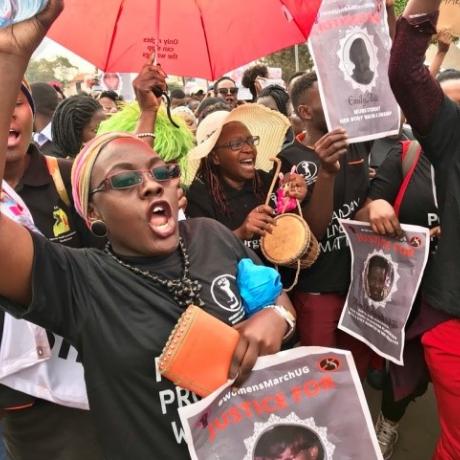 Women match during a protest against increased women murders in Uganda