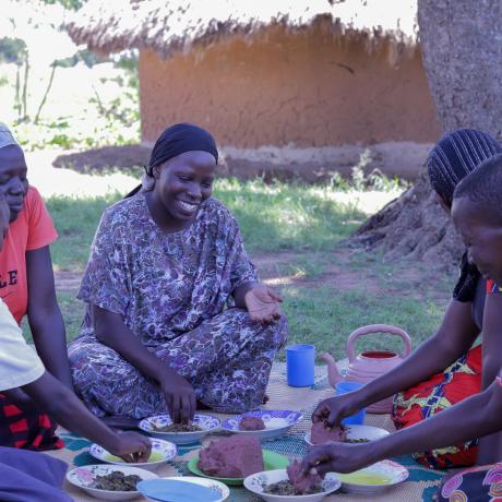 Naima Isa, the Board Liason Officer, AAIU, shares a meal with her host family.