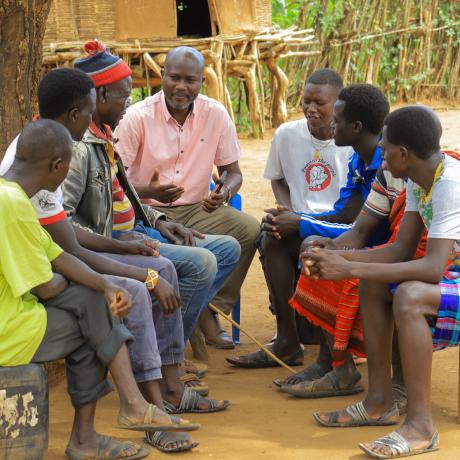 Emmanuel Ochieng, a legal officer with ActionAid International, speaks to a team of Male Action Group members