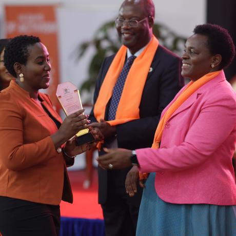 Angel Akoth, the GBV Coordinator at ActionAid International receives her award from Hon. Peace Mutuzo