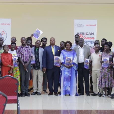 Participants take a group photo with copies of the brief during the launch