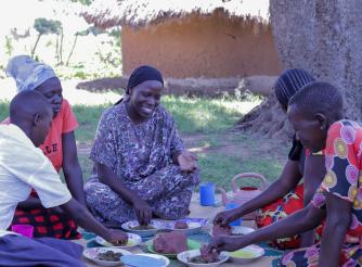Naima Isa, the Board Liason Officer, AAIU, shares a meal with her host family.