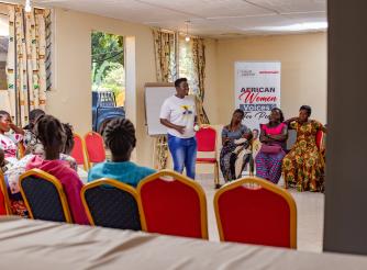 Stella shares her experience with the women during the training