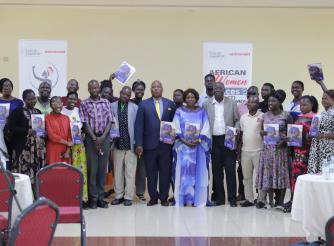 Participants take a group photo with copies of the brief during the launch
