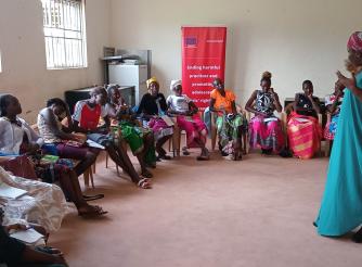 ActionAid legal officer, Christine Adokorach, speaks to community members during the feminist training