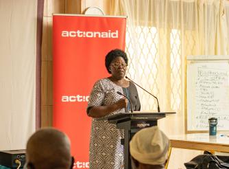 Honourable Betty Acan Aol, the Gulu Women Member of Parliament shares a light moment with district leader at the Integrity Forum
