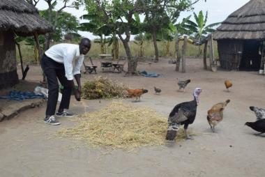 Emorut pours out some feeds for the birds